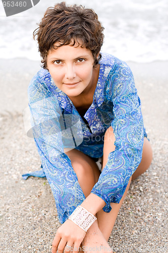 Image of woman in blue dress on the beach