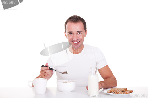 Image of handsome man taking breakfast