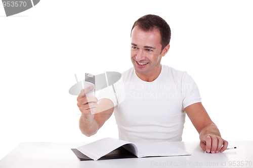 Image of man at the desk and on the phone