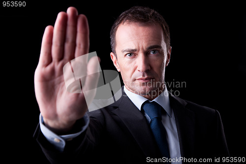 Image of Businessman with his hand raised in signal to stop