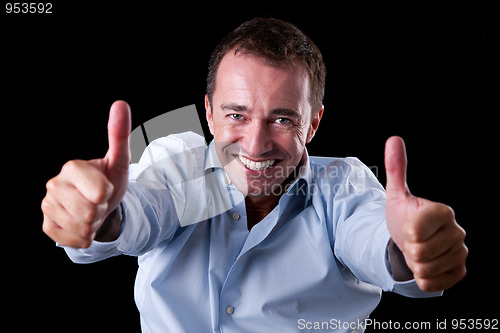 Image of Young businessman with thumb raised as a sign of success