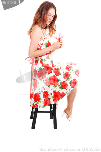 Image of Woman sitting on chair.