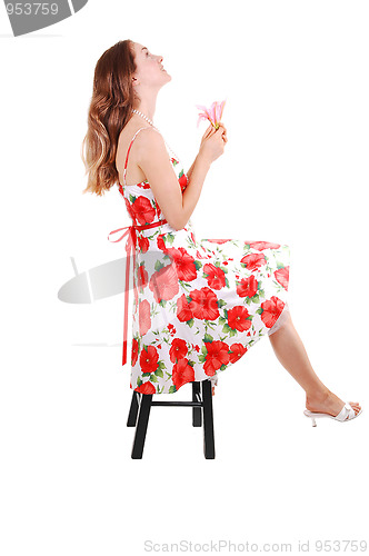 Image of Woman sitting on chair.