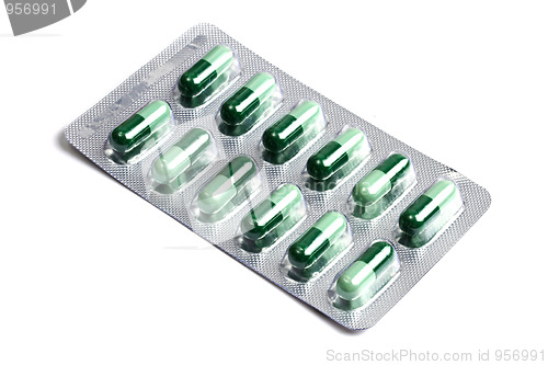 Image of Package of green capsules  isolated on white