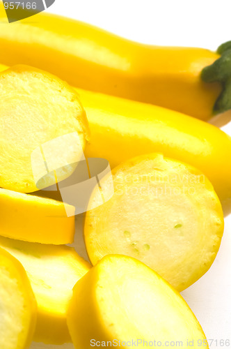 Image of two yellow zucchini squash with slices