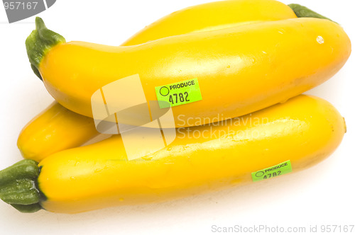 Image of three yellow zucchini squash with slices