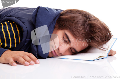 Image of young man lying asleep on a book