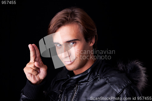 Image of Portrait of a young man with two fingers  up