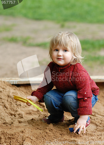Image of child plays with sand