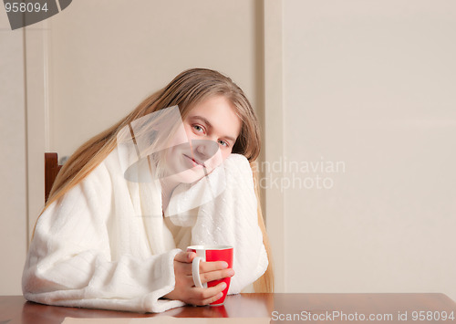 Image of young woman with coffee in morning