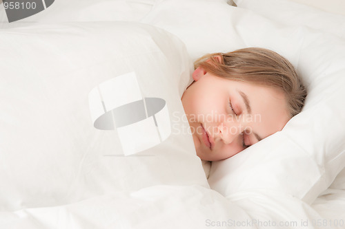 Image of young woman asleep in bed