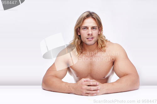 Image of Athletic sexy male body builder with the blonde long hair. gladi