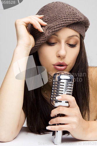 Image of Sexy woman singing in retro mic