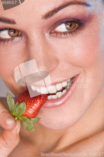 Image of Image of beautiful girl holding strawberry