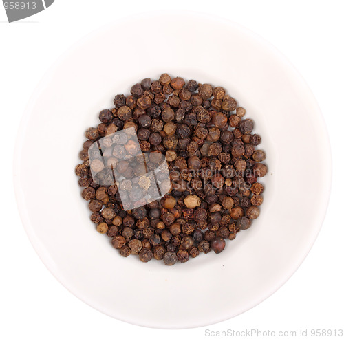 Image of Heap of black pepper on white plate