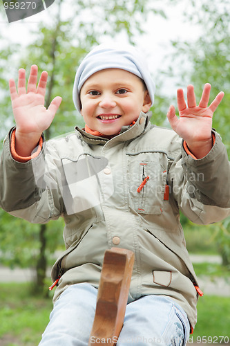 Image of Smiling boy on seesaw