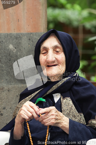 Image of Smiling elderly woman with beads