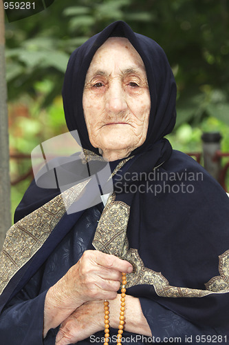 Image of Elderly woman with beads