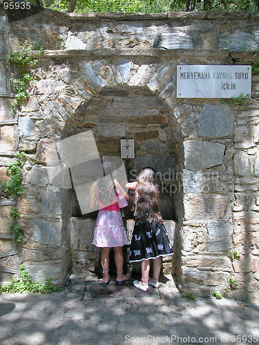 Image of Two girls drink at the spring of Meryemana (Virgin Mary's House)