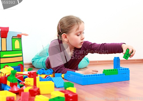 Image of Adorable girl playing with blocks