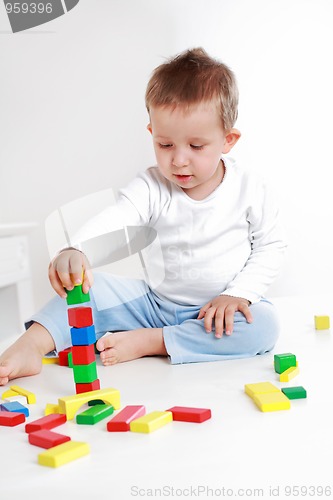 Image of Lovely boy playing with blocks