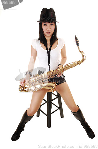 Image of A saxophonist sitting.