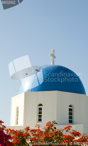 Image of Greek island blue dome church with flowers