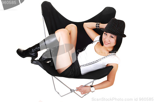 Image of Asian girl lying in a butterfly chair.