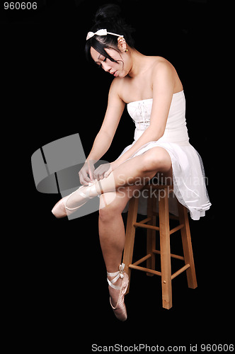 Image of Ballerina lying her ballet slippers.