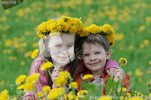 Image of Brother and sister with dandelion garlands