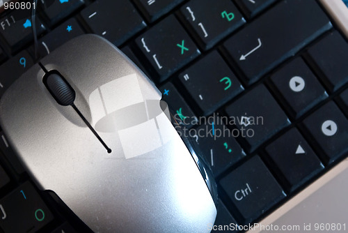 Image of The mouse is on the keyboard laptop.