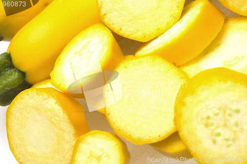 Image of two yellow zucchini squash with slices