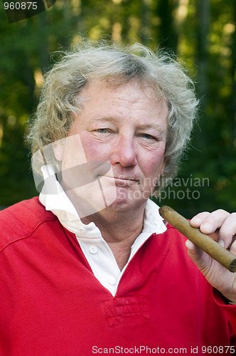 Image of senior man smoking big cigar