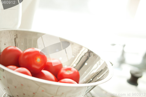 Image of Fresh, Vibrant Roma Tomatoes in Colander with Water Drops