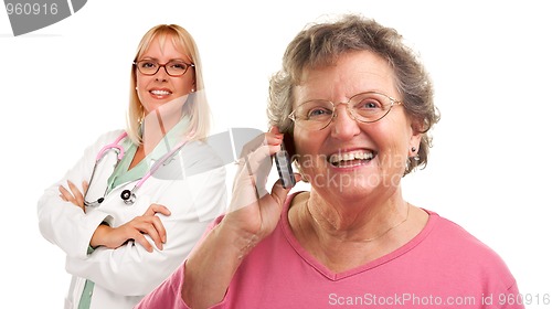 Image of Senior Woman Using Cell Phone with Female Doctor Behind
