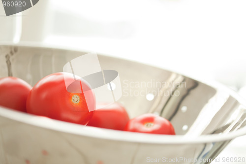 Image of Fresh, Vibrant Roma Tomatoes in Colander with Water Drops