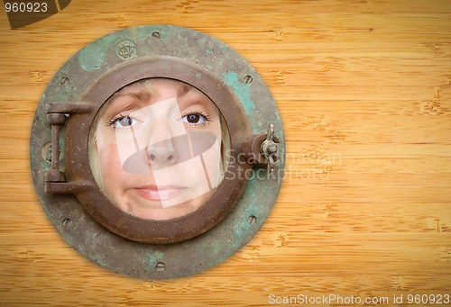 Image of Antique Porthole on Bamboo Wall with Funky Woman Looking Through