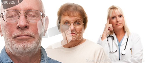Image of Concerned Senior Couple and Female Doctor Behind