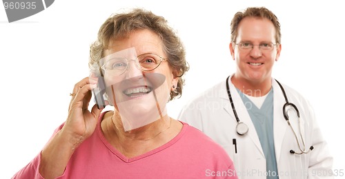 Image of Happy Senior Woman Using Cell Phone with Male Doctor Behind