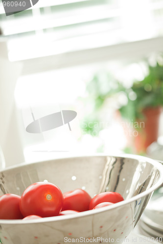 Image of Fresh, Vibrant Roma Tomatoes in Colander with Water Drops