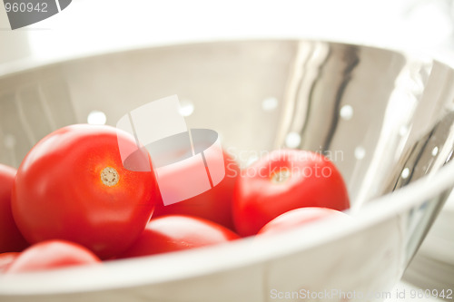 Image of Fresh, Vibrant Roma Tomatoes in Colander with Water Drops