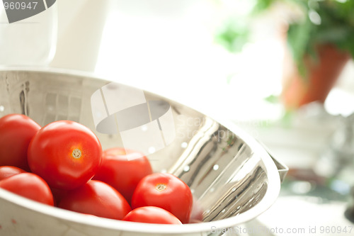 Image of Fresh, Vibrant Roma Tomatoes in Colander with Water Drops