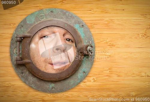 Image of Antique Porthole on Bamboo Wall with Funky Man Looking Through