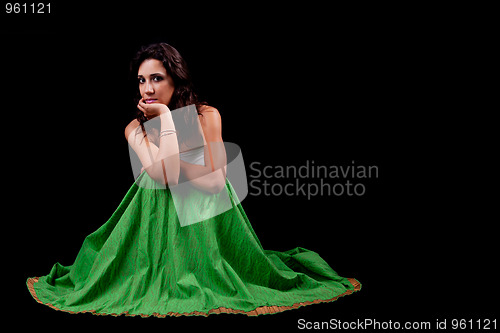 Image of young and beautiful woman  seated and pensive