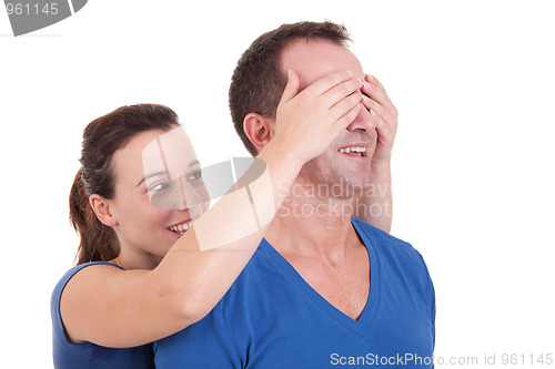 Image of Portrait of a happy woman covering his man eyes, to surprise him