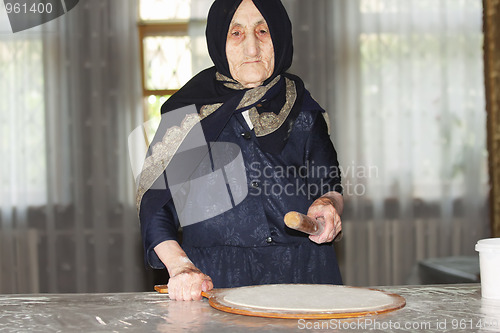 Image of Elderly woman with rolling pin