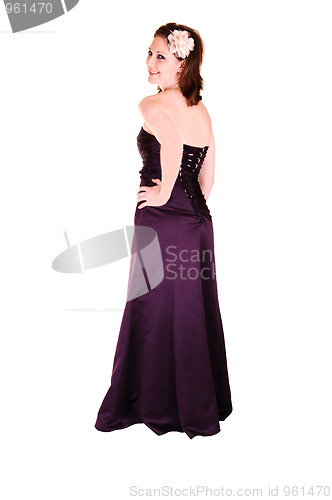 Image of Young pretty girl standing in burgundy evening dress.