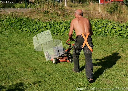 Image of Senior mowing a lawn