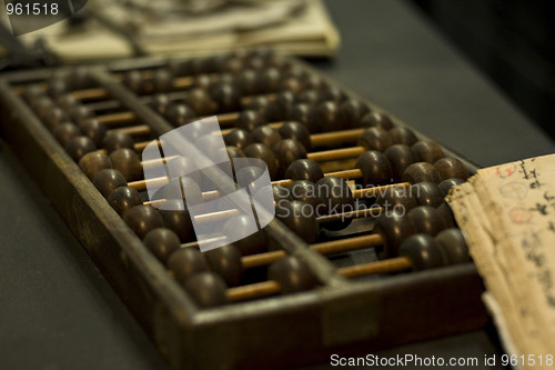 Image of abacus and book on the table 