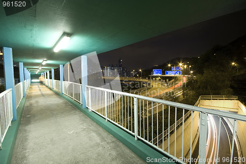 Image of view on footbridge of modern urban city with Freeway Traffic at 